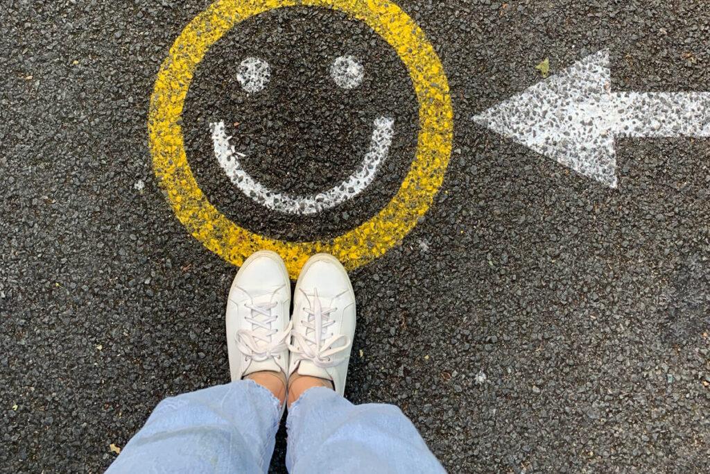 What is Employee Motivation, Actually? Painted happy face on tar